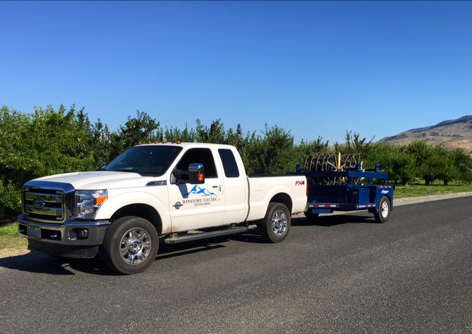 Wenatchee Valley Electric work truck and equipment trailer on a job site