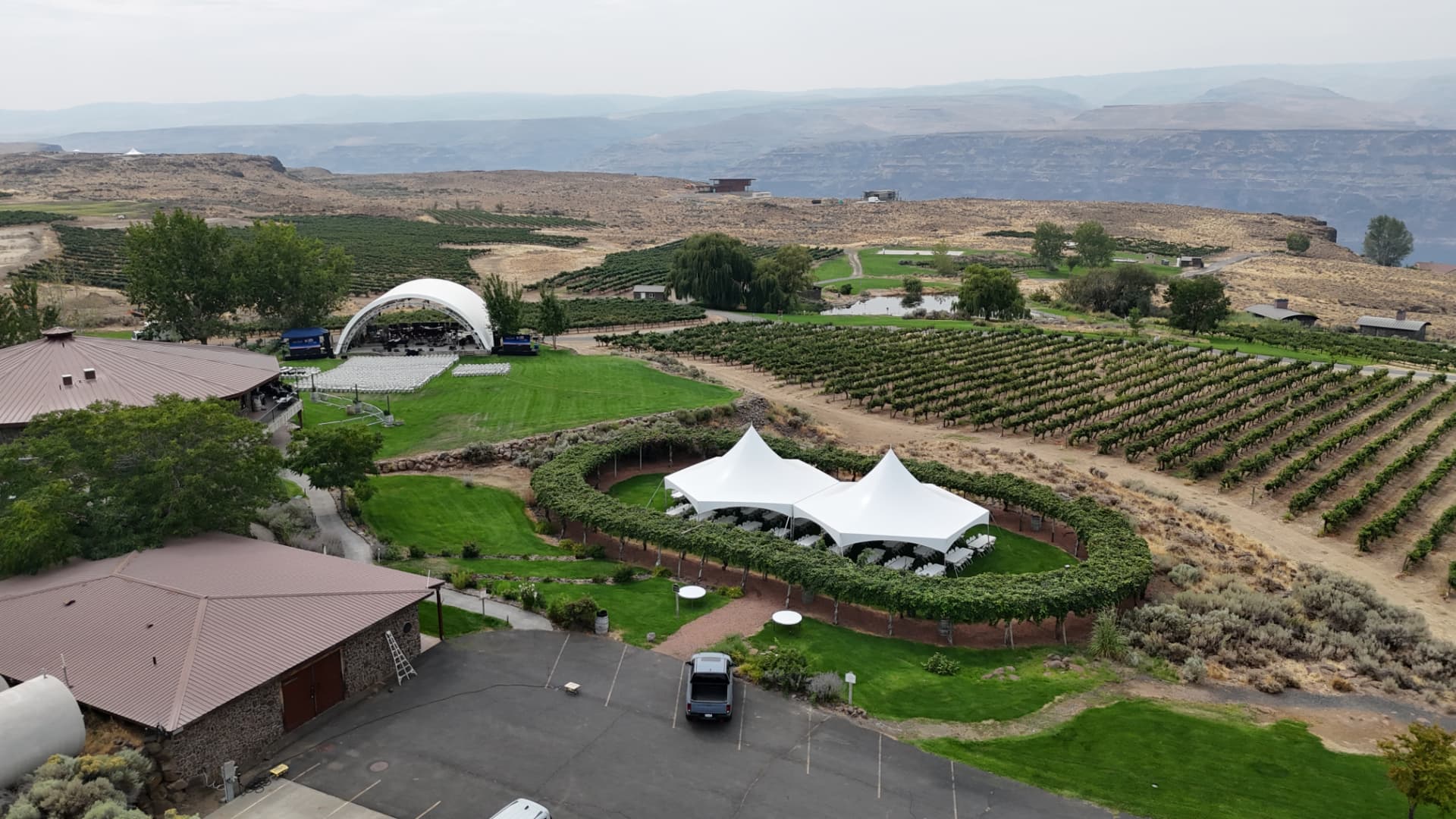 Event tents installed among vineyard rows by NCW Event Rentals