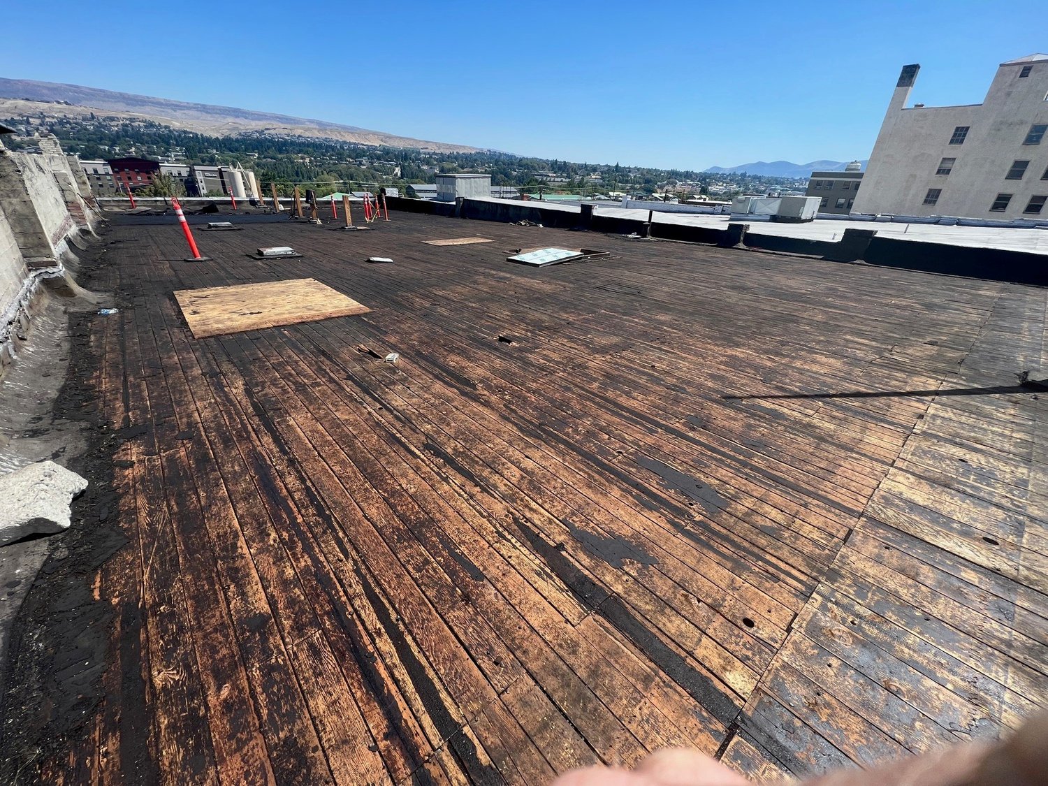An Asbestos Central crew member performing an asbestos roof abatement in full protective gear