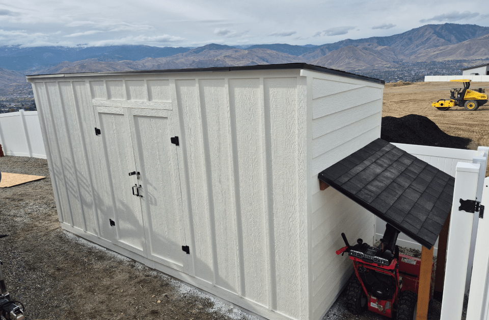 Completed white storage shed and covered equipment area by Frame 2 Finish