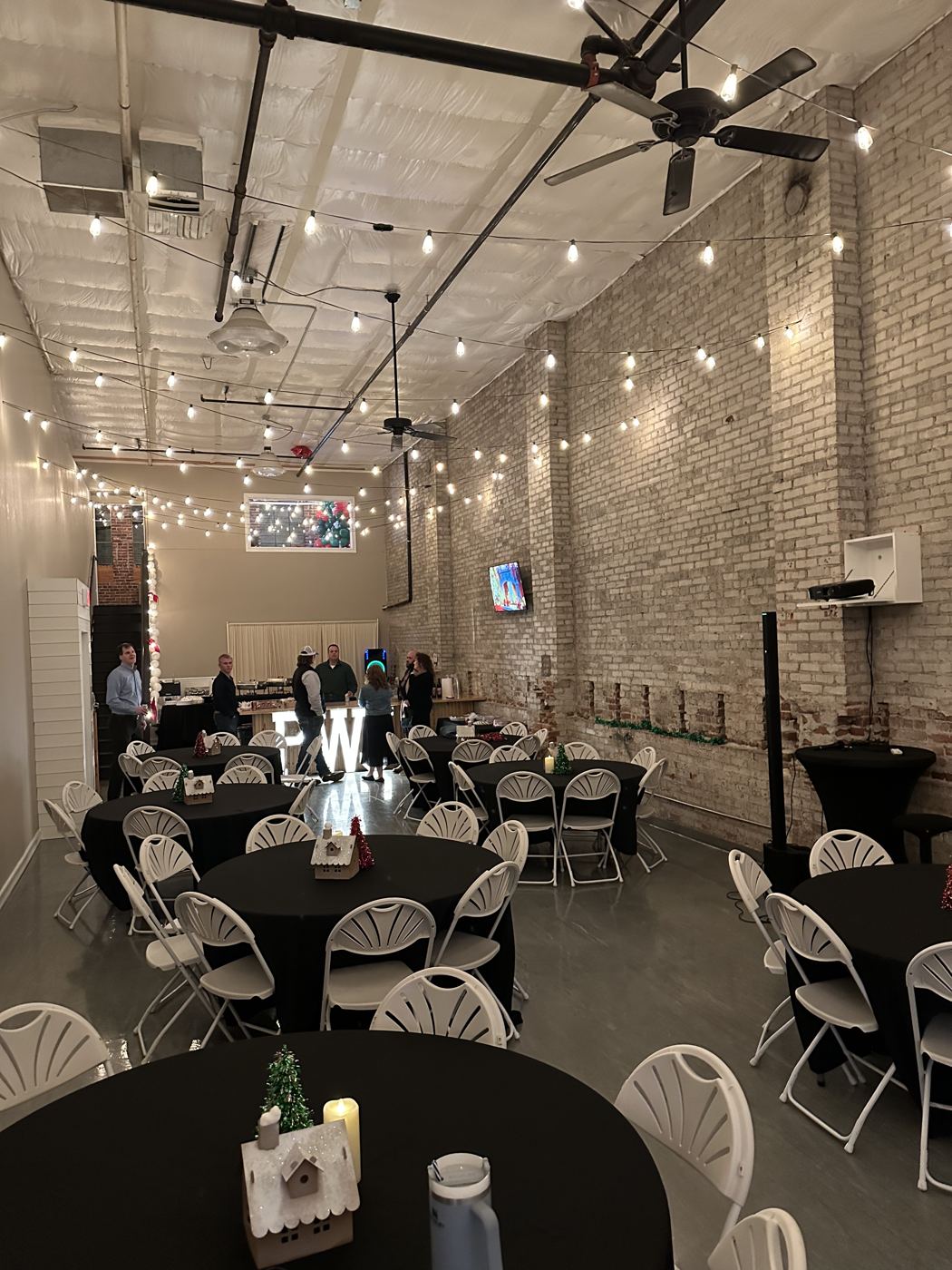 Celebration setup with balloons and long tables at Host Wenatchee