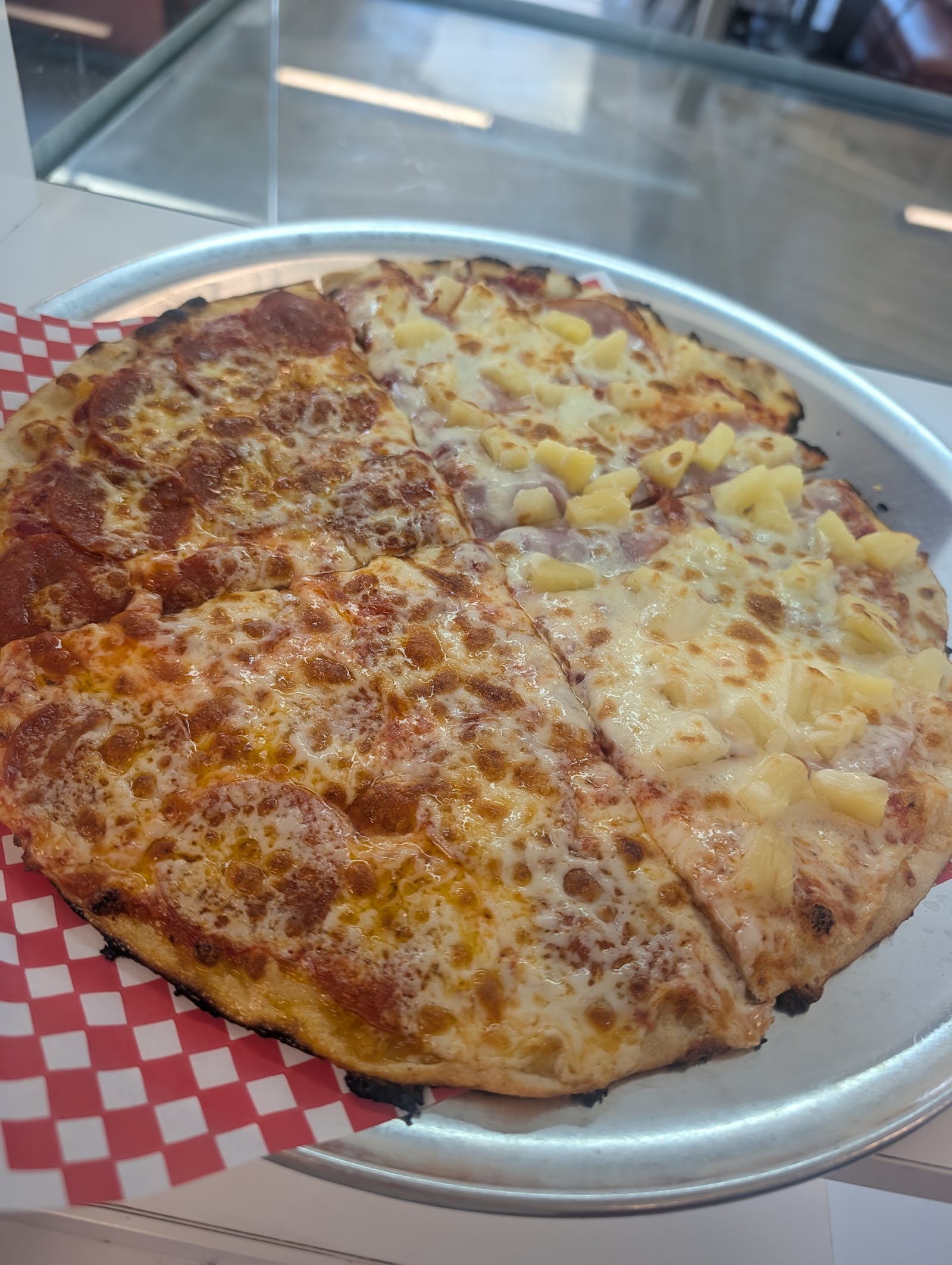 Half-and-half classic pizza served on a metal tray at The Valley Pizza Joint